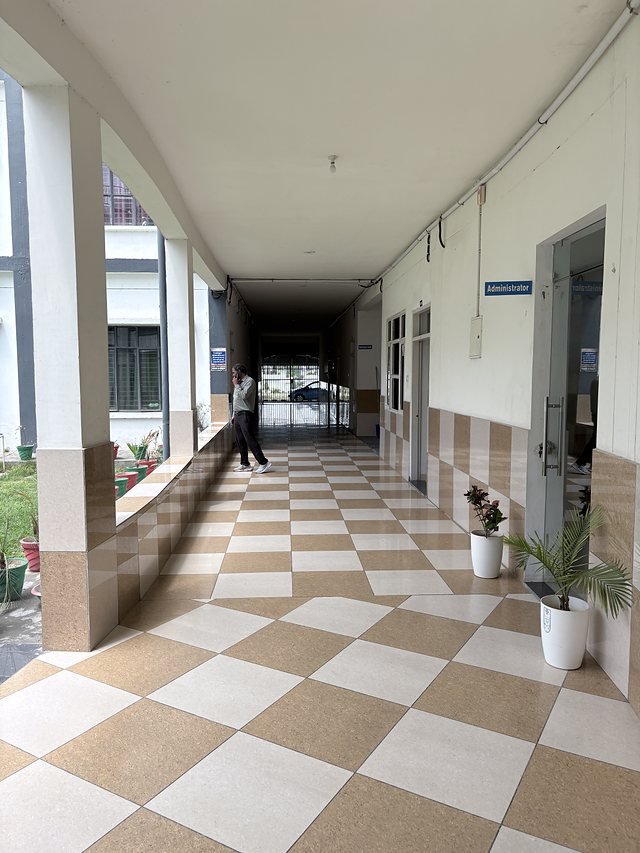 A corridor looking down the academic block with air conditioning units along the wall