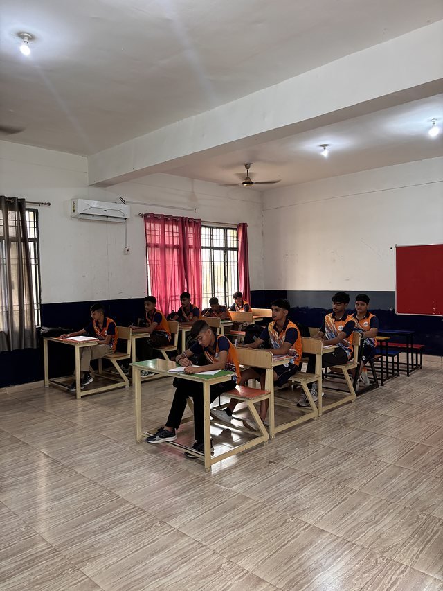 A classroom in session with a wall-mounted air conditioning unit