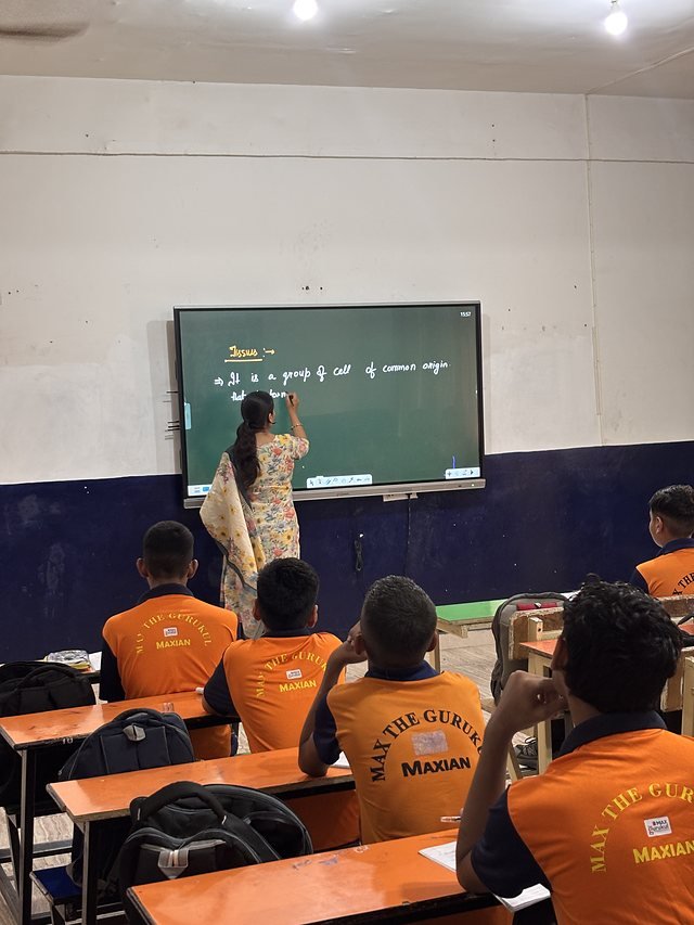 A small group of students at the board during a doubt-clearing class