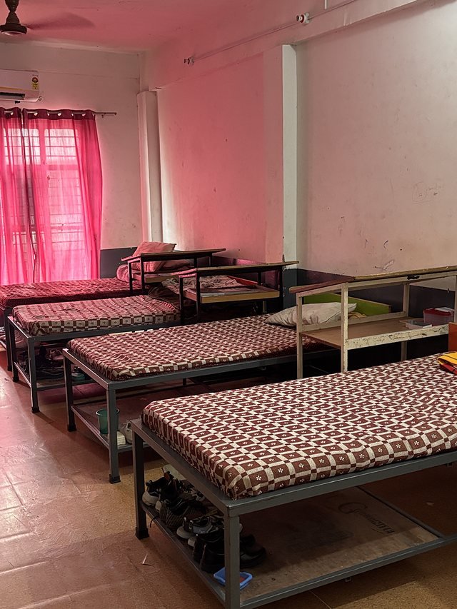 Bunk beds and wardrobes along a hostel wing